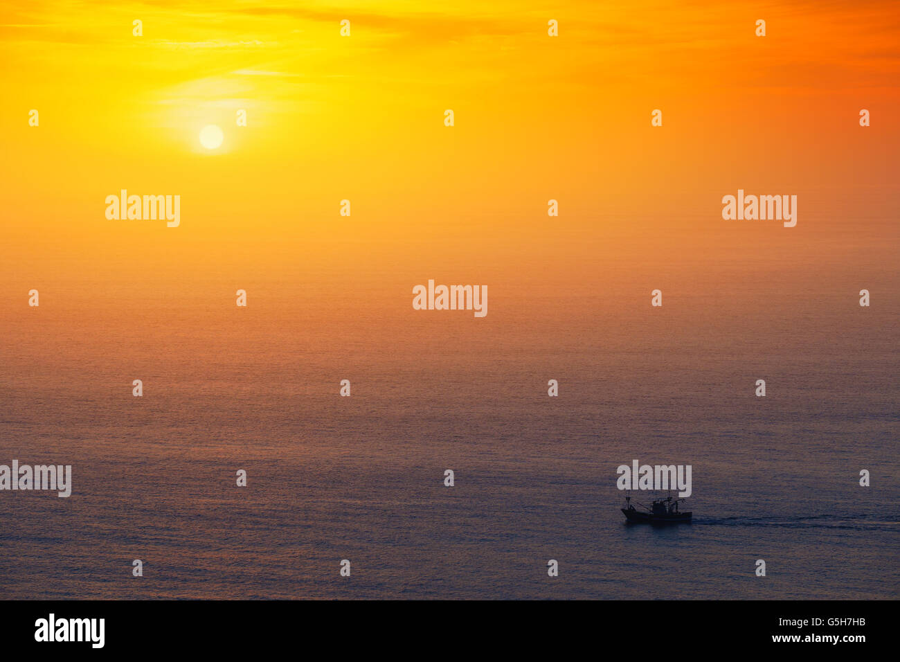fishing ship at the sunset Stock Photo