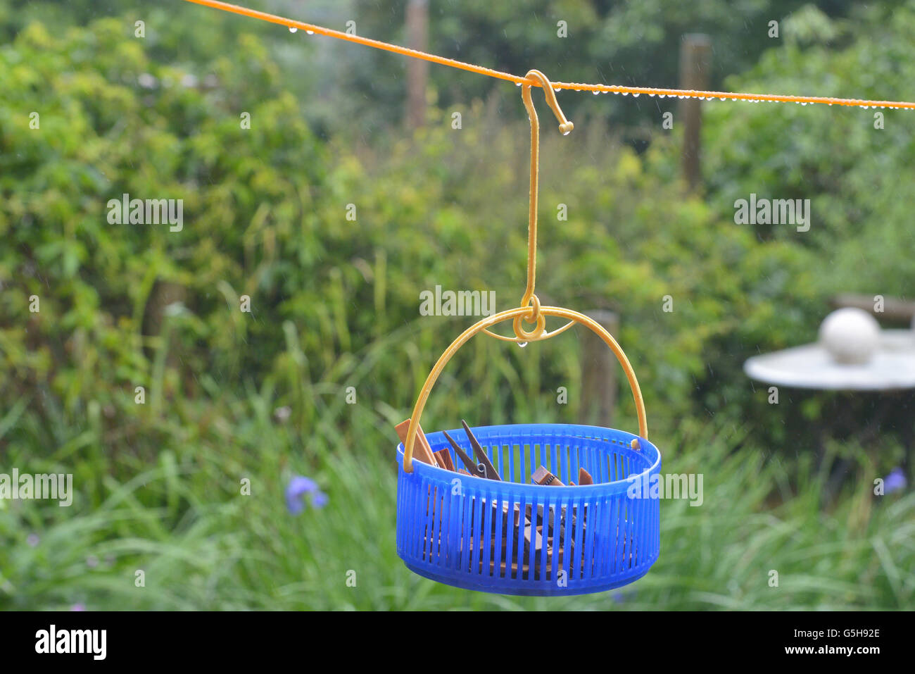 Washing line and clothes peg bag in the rain. England. UK Stock Photo