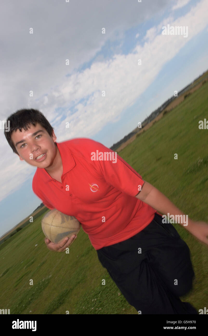 Schoolboy running with a rugby ball. England. UK Stock Photo