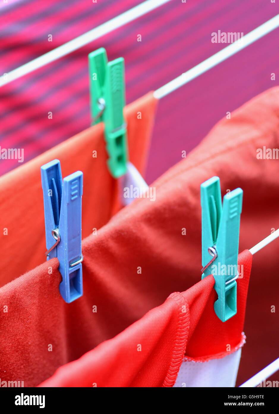 Clothespins On Clothesline Securing The Red Wet Clothes Red Wet