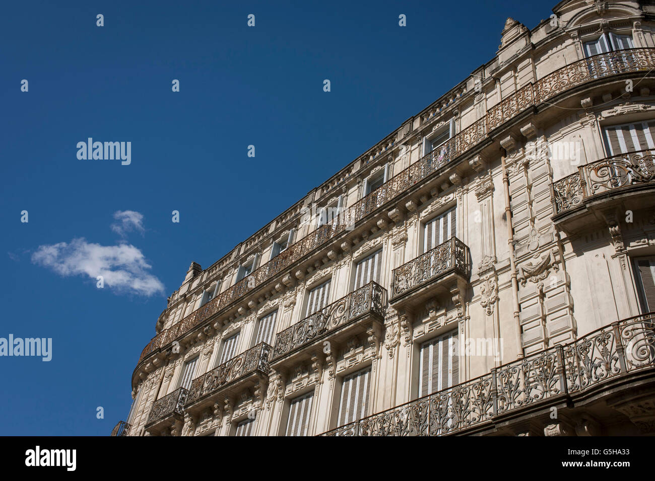 Architecture of apartments with ornate iron railings on Rue Foch in