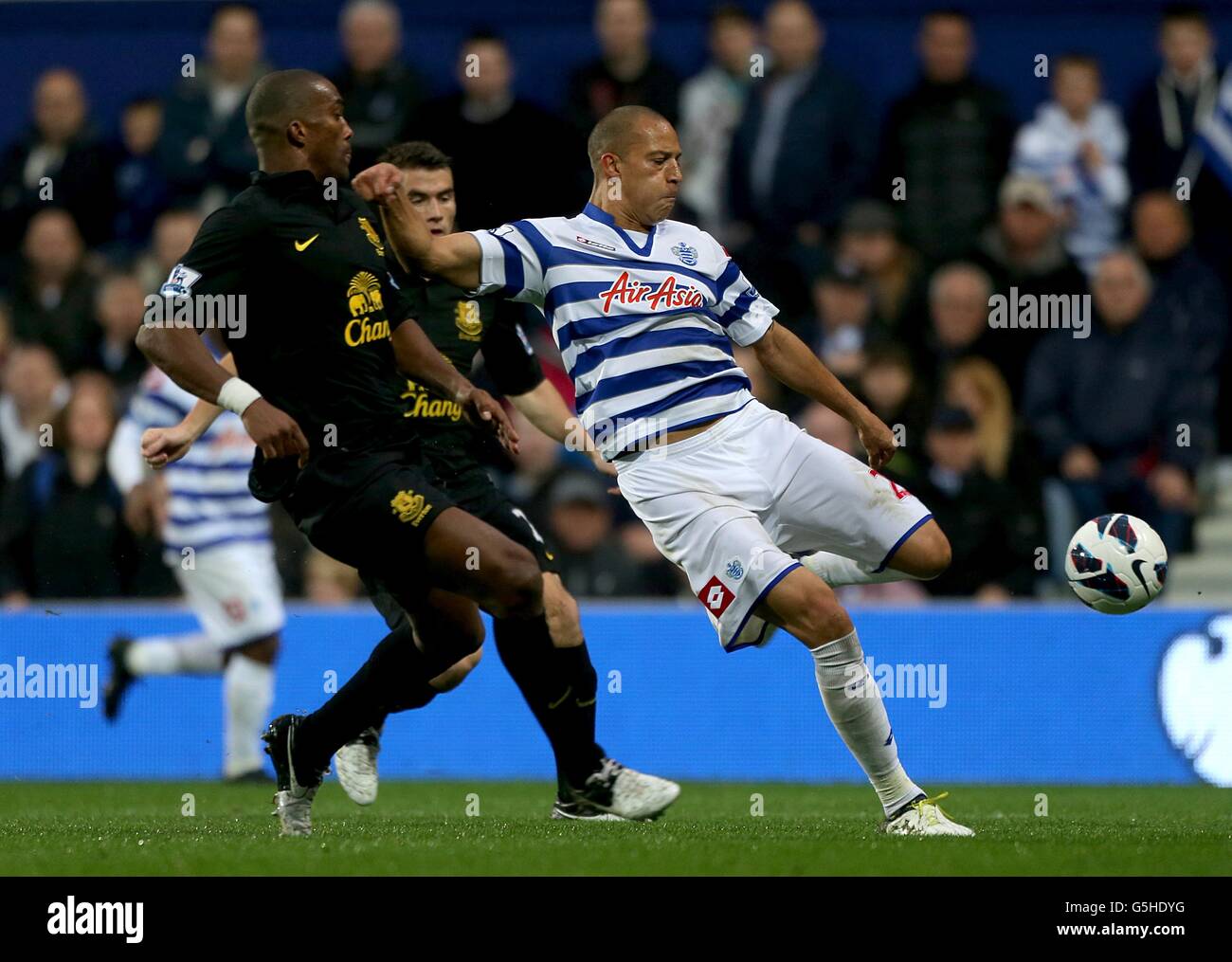 Queens Park Rangers' Bobby Zamora (right) and Everton's Sylvain Distin in action Stock Photo