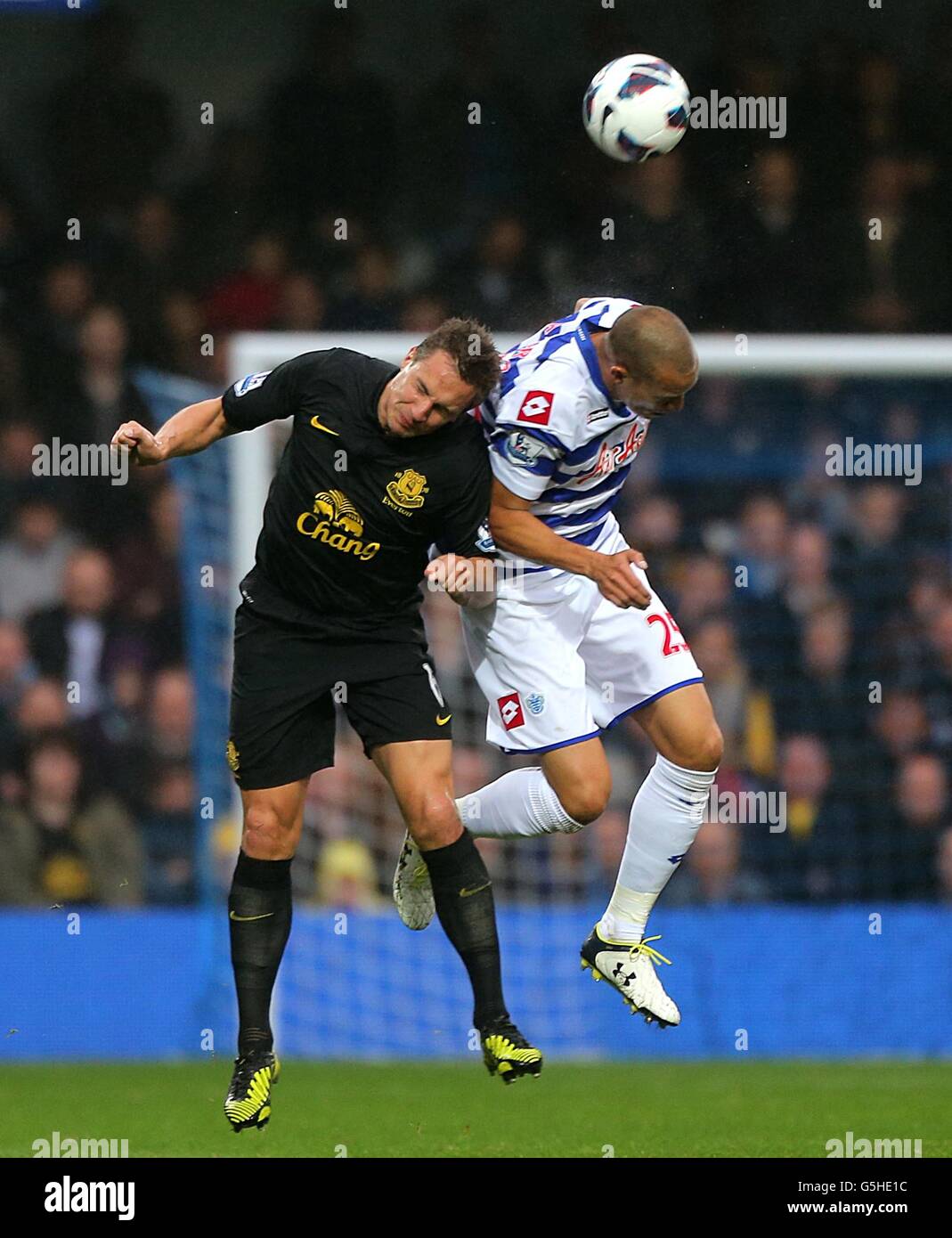 Everton's Phil Jagielka (left) and Queens Park Rangers' Bobby Zamora battle for the ball Stock Photo
