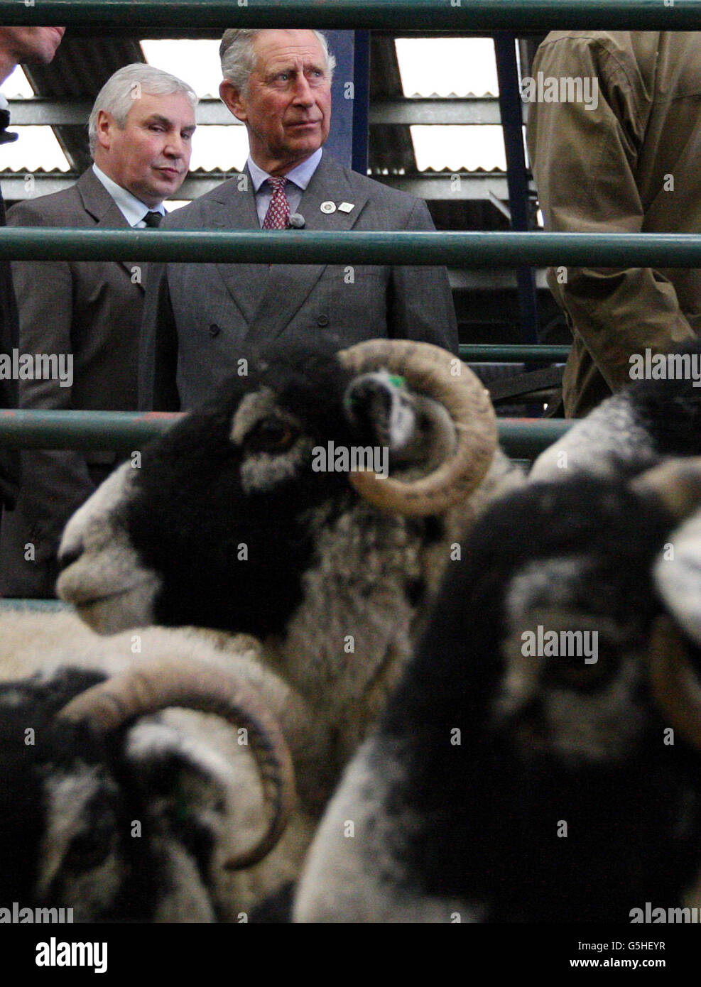 The Prince of Wales talks with farmers in the auction mart at Middleton