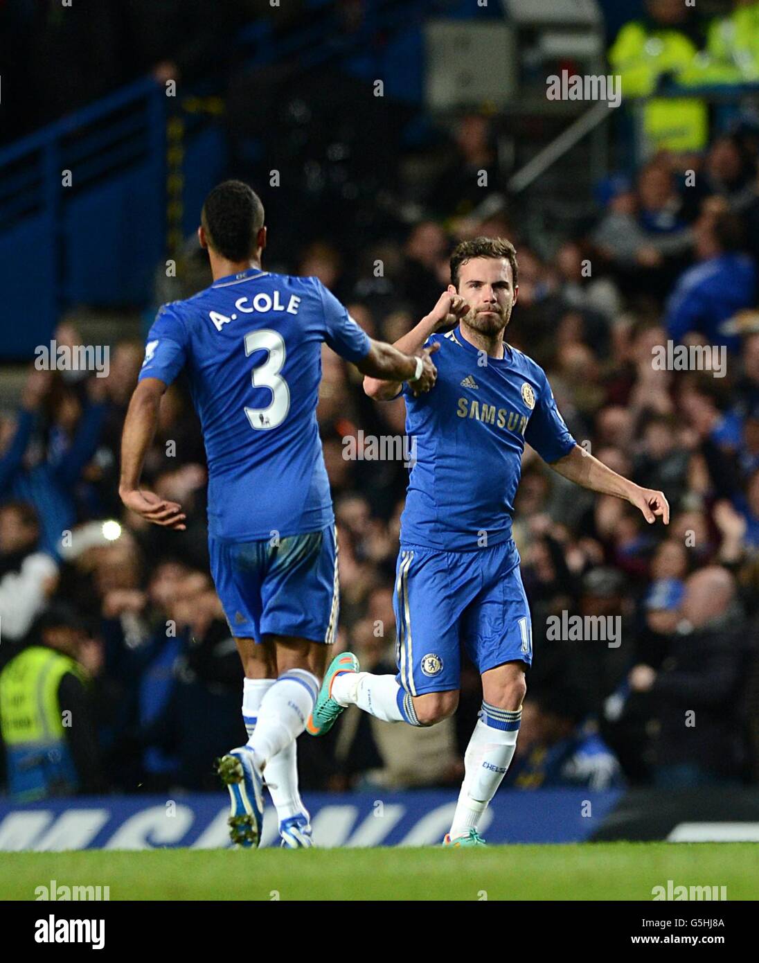 Chelsea's Juan Mata celebrates scoring his side's first goal of the game from a free kick with teammate Ashley Cole (left) Stock Photo