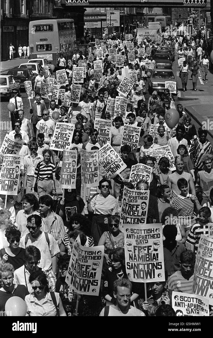 Thousands of placard bearing demonstrators march through the streets of ...