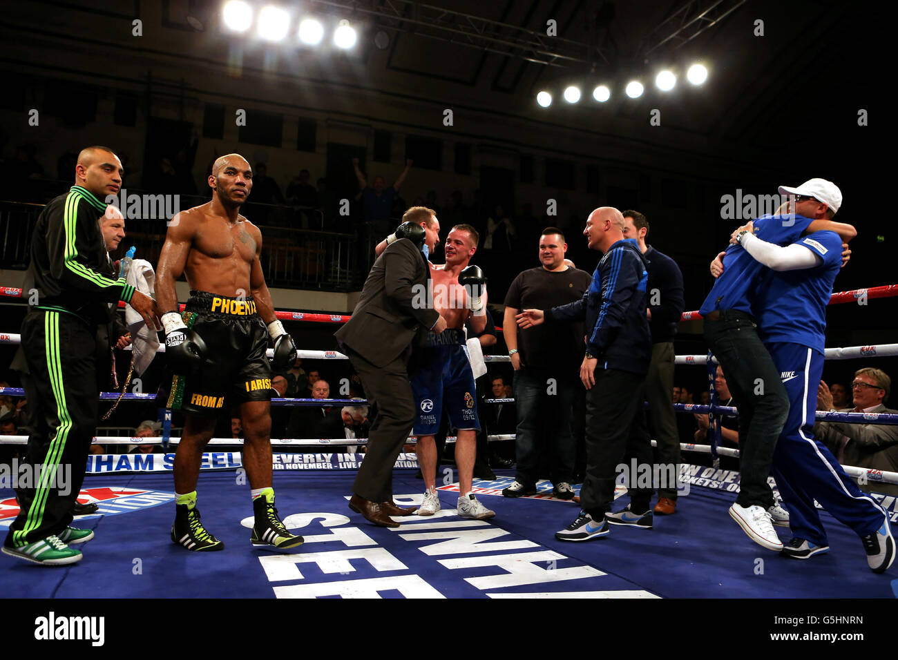 Frankie Gavin (centre) reacts with his corner after beating Junior Witter (second right) who stands dejected during there British Welterweight Title fight at York Hall, London. Stock Photo