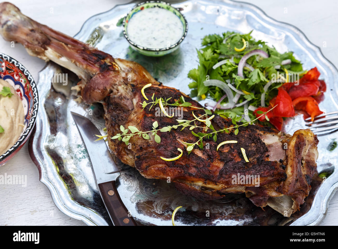 Roasted shoulder on a steel plate, top view Stock Photo