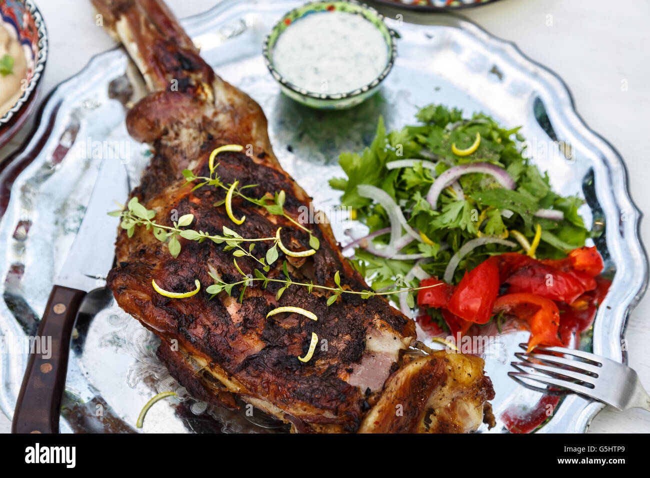 Roast shoulder of lamb on a steel plate, top view Stock Photo
