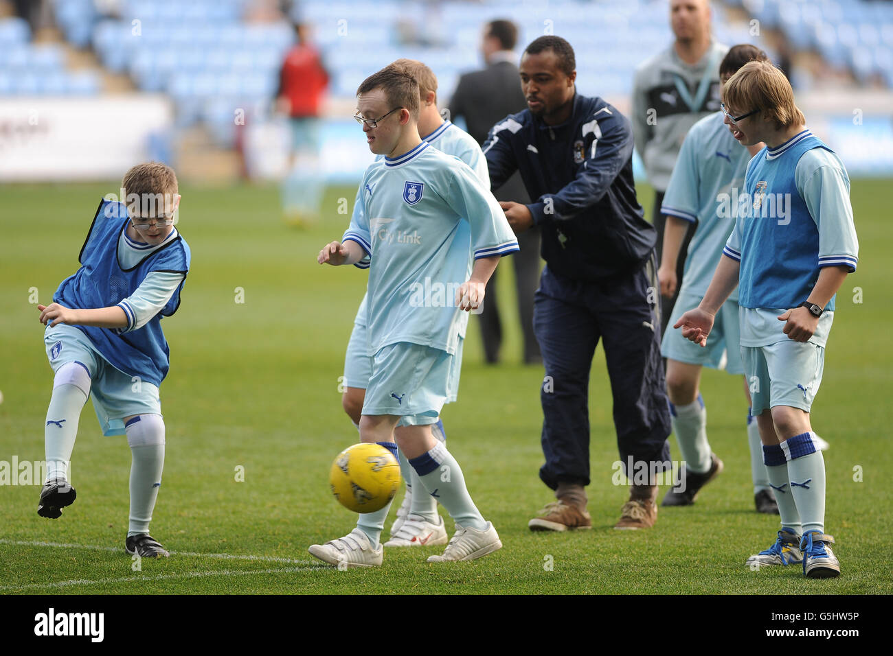 Coventry City Downs Syndrome team on the pitch at half time during the npower Football League One match at the Ricoh Arena, Coventry. Stock Photo