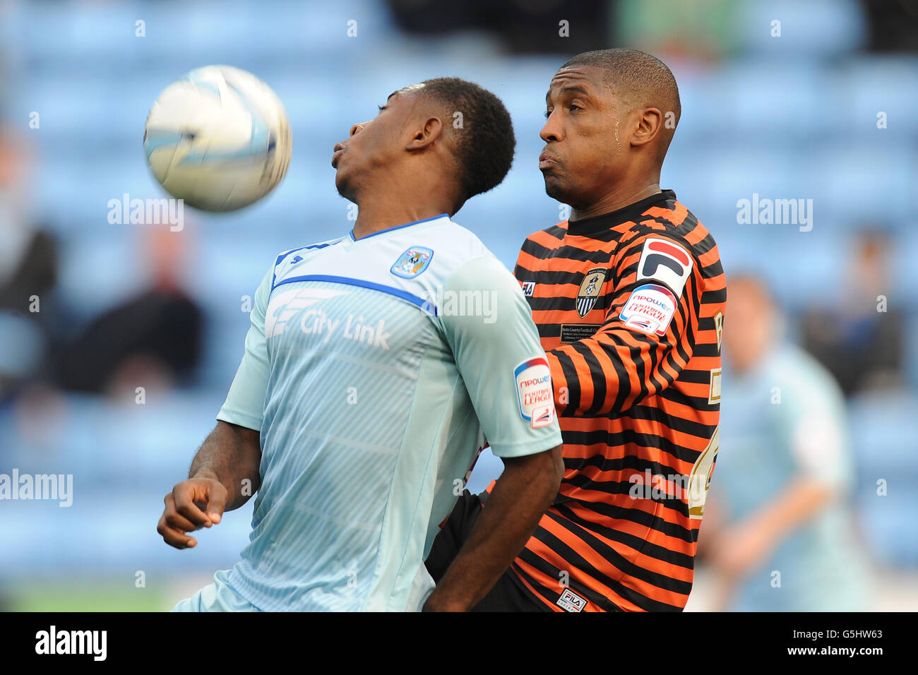 Coventry City's Franck Moussa and Notts County's Andre Boucaud battle for the ball during the npower Football League One match at the Ricoh Arena, Coventry. Stock Photo
