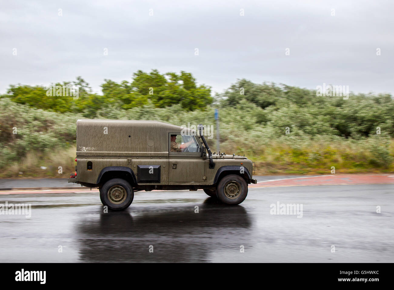 Snatch Army Land Rover LWB 110 with snorkel exhaust, en-route to Southport's Victoria Park, in Merseyside, UK, for the Woodvale Transport Vehicle of Festival Classics. Vintage, Military, collectable cars Stock Photo