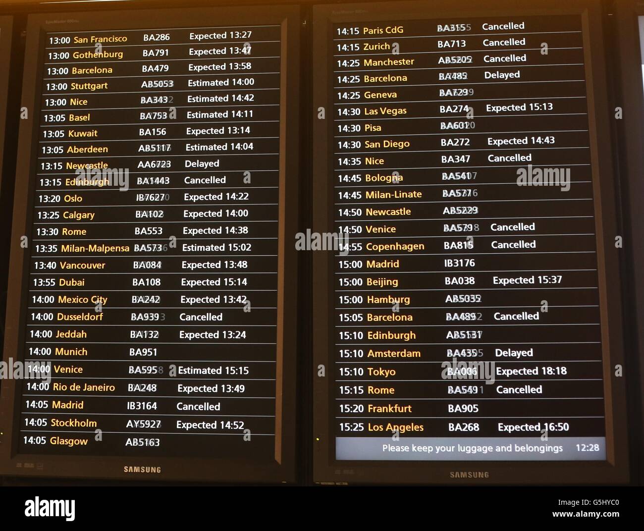 A view of an arrivals board in Terminal 5 at Heathrow Airport, as fog affected flights for a second day. Stock Photo