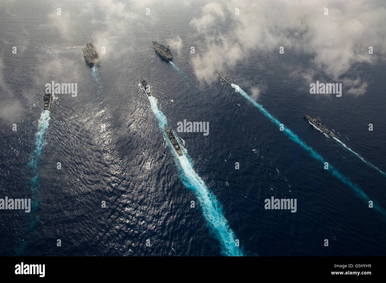 U.S Navy Nimitz-class nuclear-powered super-carrier USS John C. Stennis, right, and USS Ronald Reagan, left, steam in formation during dual operations June 18, 2016 in the Philippine Sea. Stock Photo