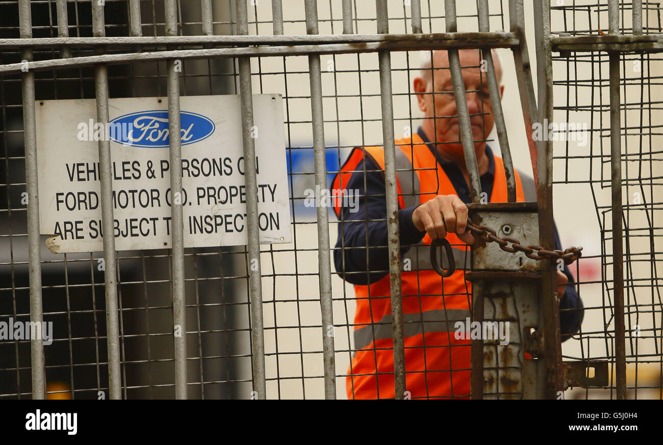 A security guard locks the gates after workers left the Ford Transit