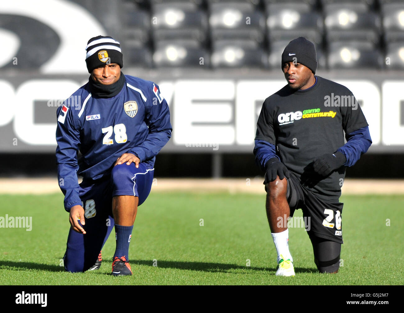 Notts County's Andre Boucaud (left) doesn't wear a One Game One Community t-shirt during warm up unlike team-mate Jamal Campbell-Ryce before during the npower League One match at Meadow Lane, Nottingham. Stock Photo