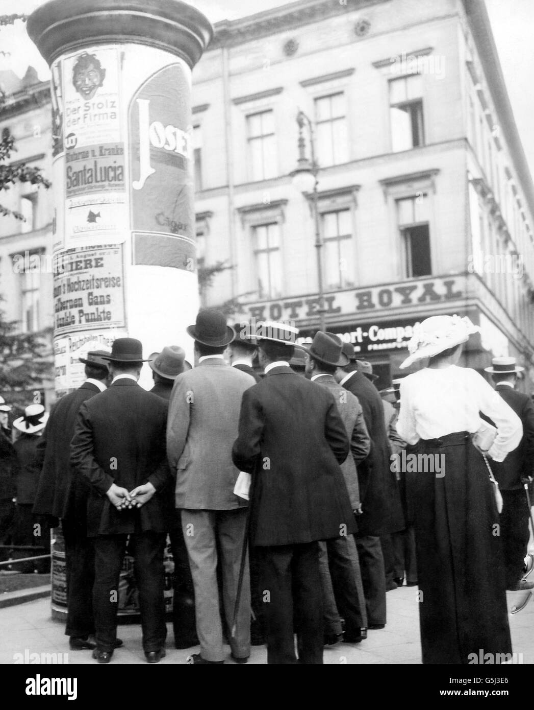 Pedestrians read war news on the Unter Den Linden in Berlin. Stock Photo