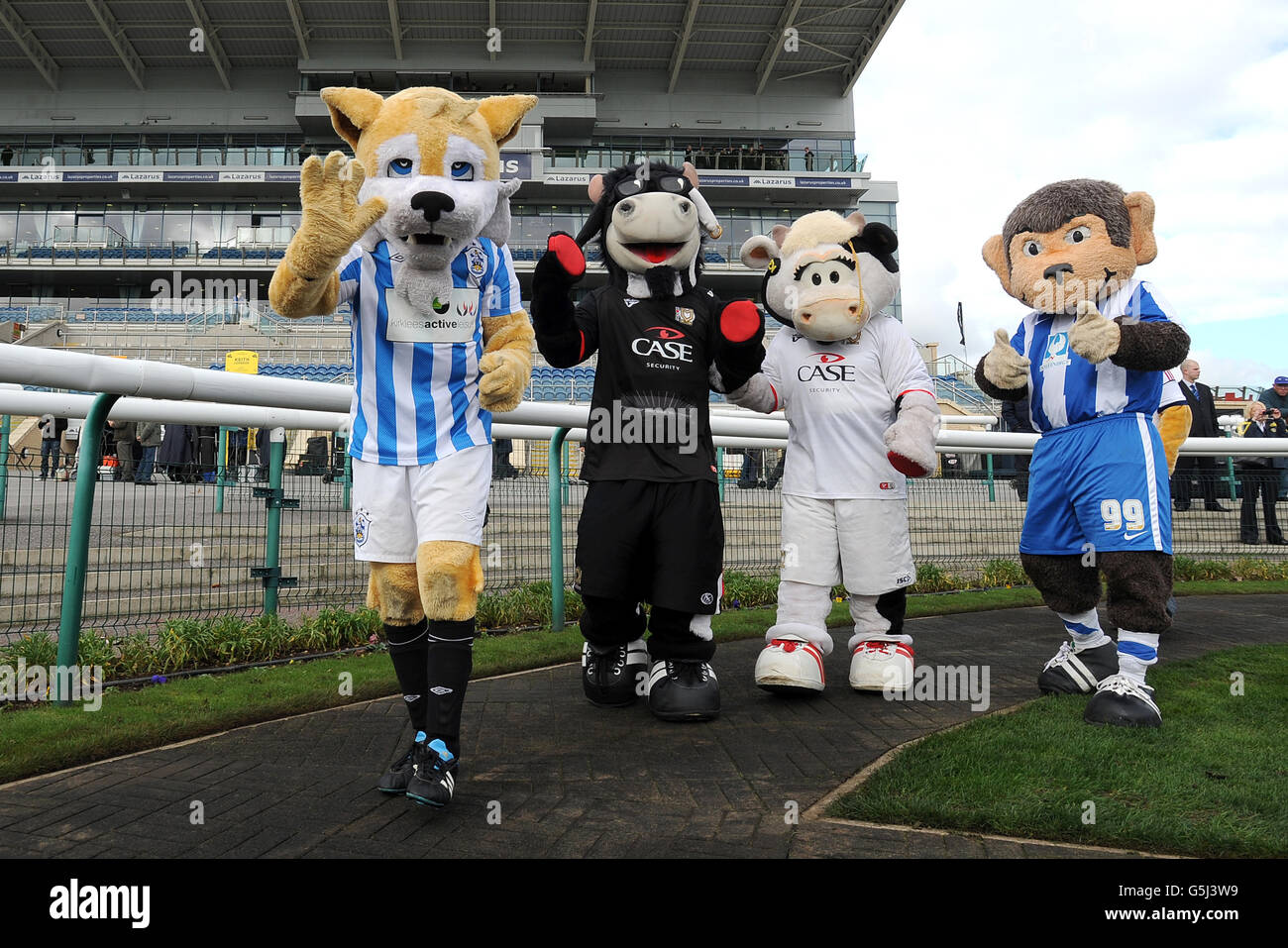 Huddersfield Town mascot Terry The Terrier, Milton Keynes Dons mascots Donny and Mooie The Cow, and Hartlepool mascot H'Angus (left to right) in the parade ring before the Football League Mascot Race, in support of Prostate Cancer UK. Stock Photo