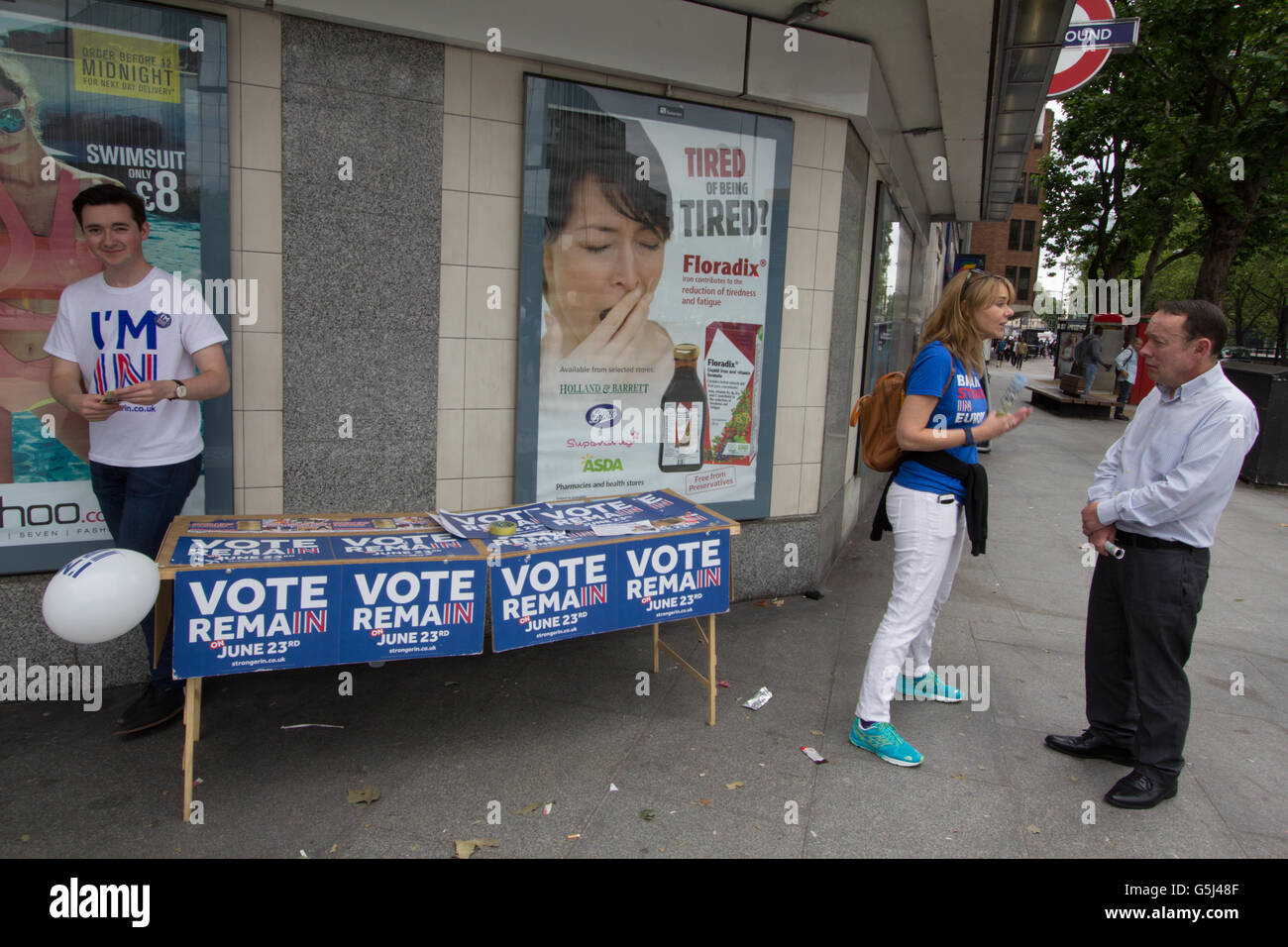 Britain stronger in Europe campaign, EU referendum Brexit, Vote Remain canvassers hand out leaflets and stickers in front of tired tiredness advert  at Warren Street in Central London, Stock Photo