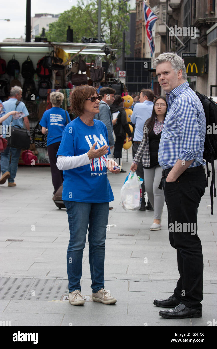 Britain stronger in Europe campaign, EU referendum Brexit, Vote Remain canvassers hand out leaflets and stickers  at Warren Street in Central London, with union Jack flag in background Stock Photo