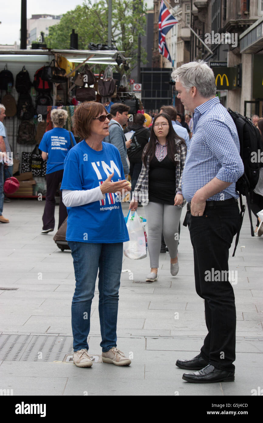 Britain stronger in Europe campaign, EU referendum Brexit, Vote Remain canvassers hand out leaflets and stickers  at Warren Street in Central London, with union Jack flag in background Stock Photo