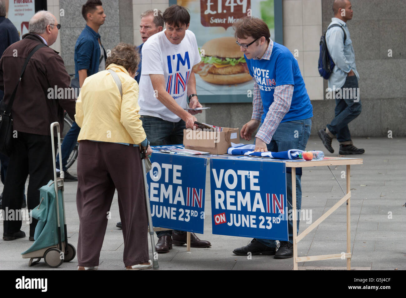 Britain stronger in Europe campaign, EU referendum Brexit, Vote Remain canvassers hand out leaflets and stickers to elderly lady  at Warren Street in Central London, Stock Photo