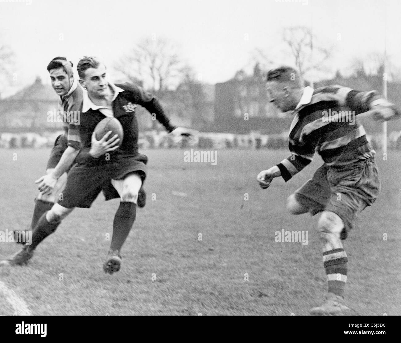 Prince Alex Obolensky (2nd left). England Rugby Union International who died in a flying accident while serving with the R.A.F. Pictured playing for Oxford University v Richmond, making one of his famous runs down the line and is about to be stopped by W.A.H. Chapman (Right) after having beaten another player . Russian born he escaped with his family during the revolution in 1917. Stock Photo