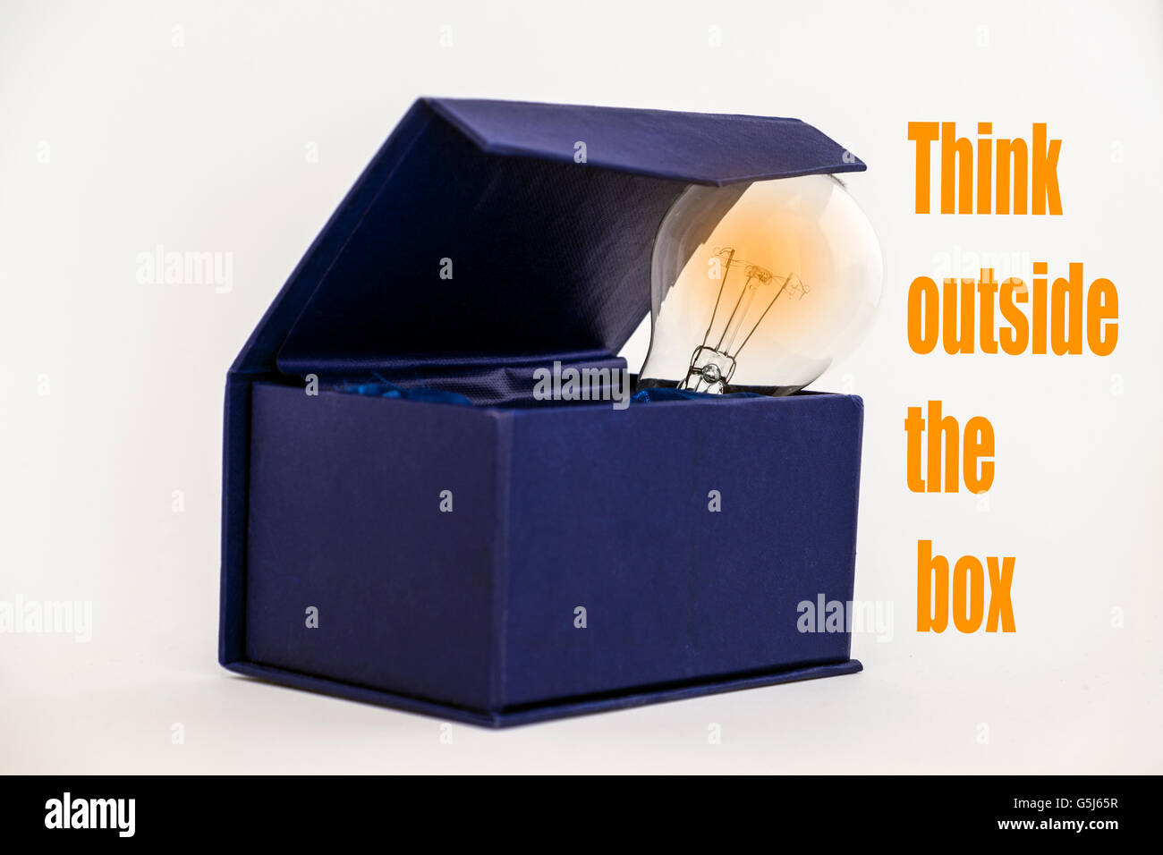 Blue box on white background with Think outside the box text Stock Photo