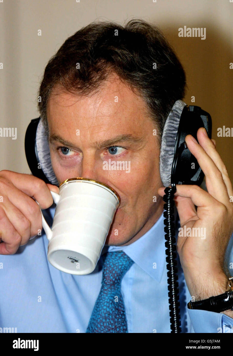 British Prime Minister Tony Blair talks a sip from his tea as he ...