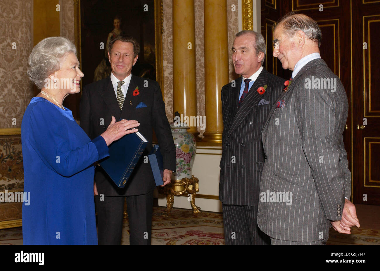 The Queen receives Brigadier Brian Harding (second right) of the Royal British Legion, who presented her with a copy of his book 'Keeping The Faith', accomapnied by Leiutenant General Sir Roderick Cordy-Simpson (left) and Brigadier Ian Townsend, at Buckingham Palace, London. Stock Photo