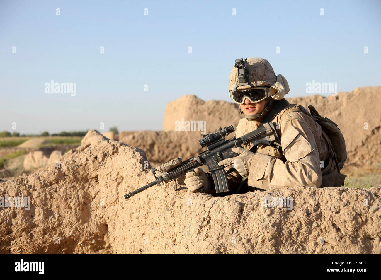 A U.S. Marine providing security during a road reconnaissance patrol in Afghanistan. Stock Photo