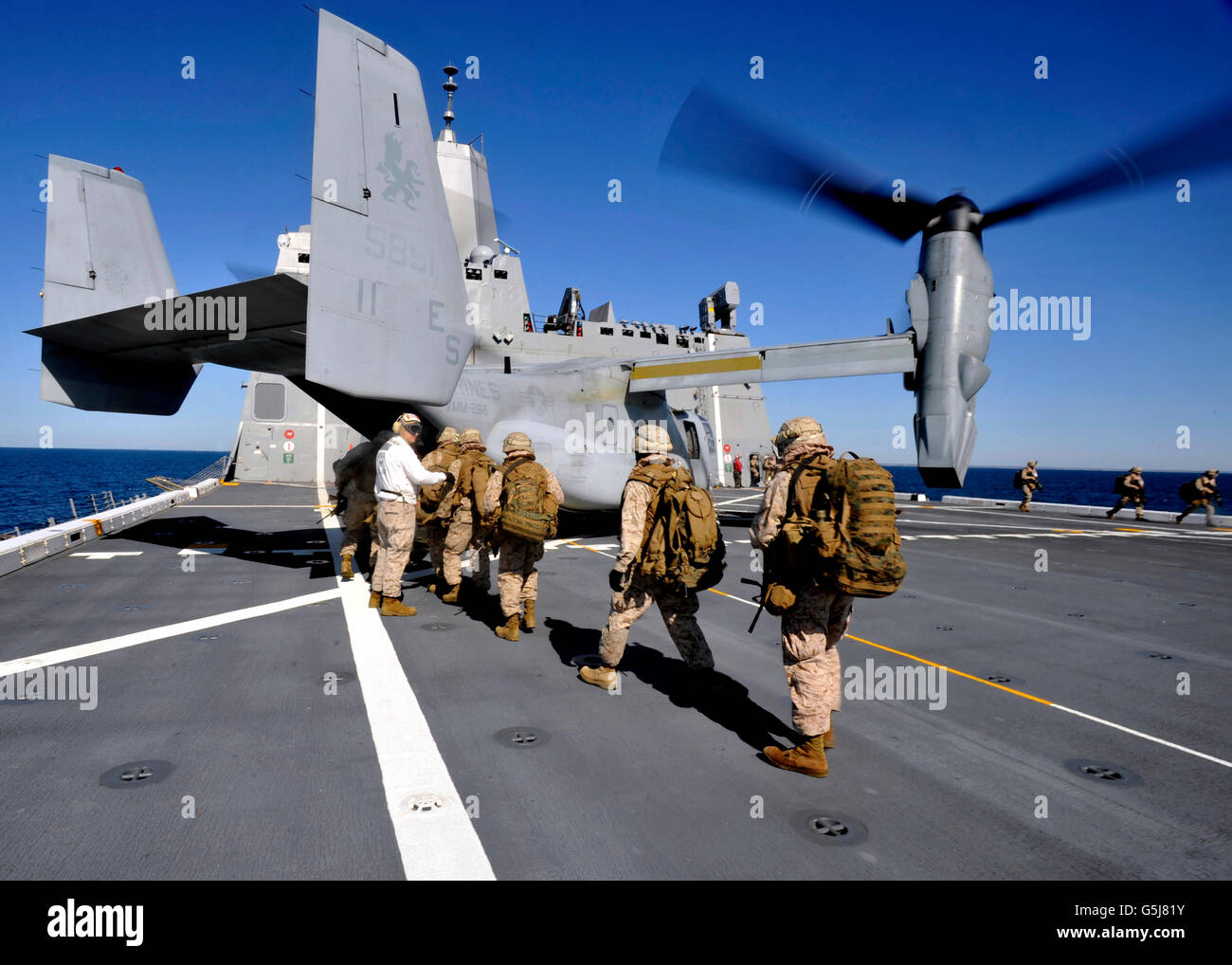 Marines board an MV-22 Osprey aboard the USS New York. Stock Photo