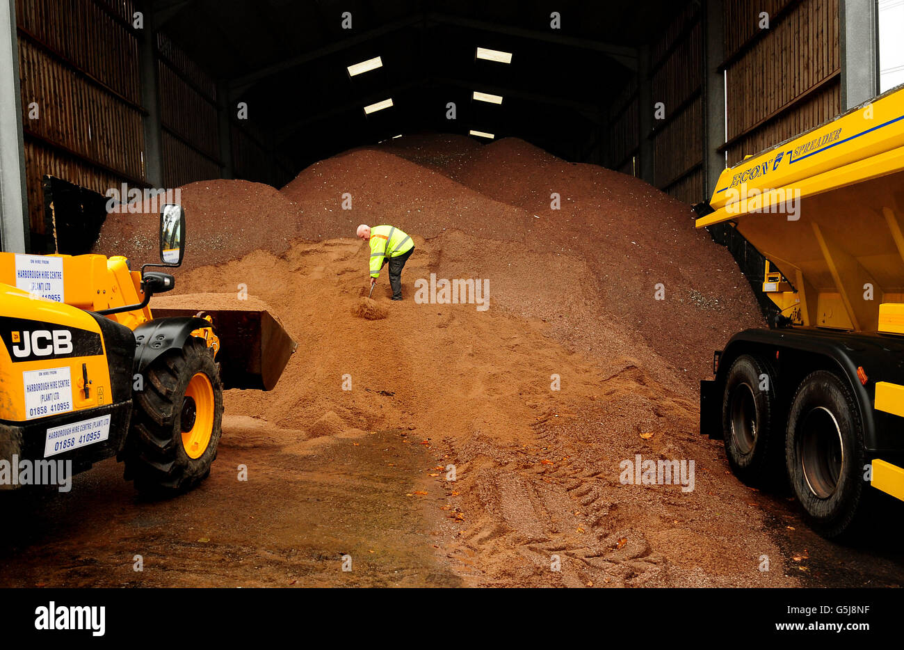 Andy Warner works on a stockpile of salt and molasses mixture used for road gritting, in preparation for the winter season at the Northern Highway Depot, Mountsorrel, Leicestershire. Stock Photo