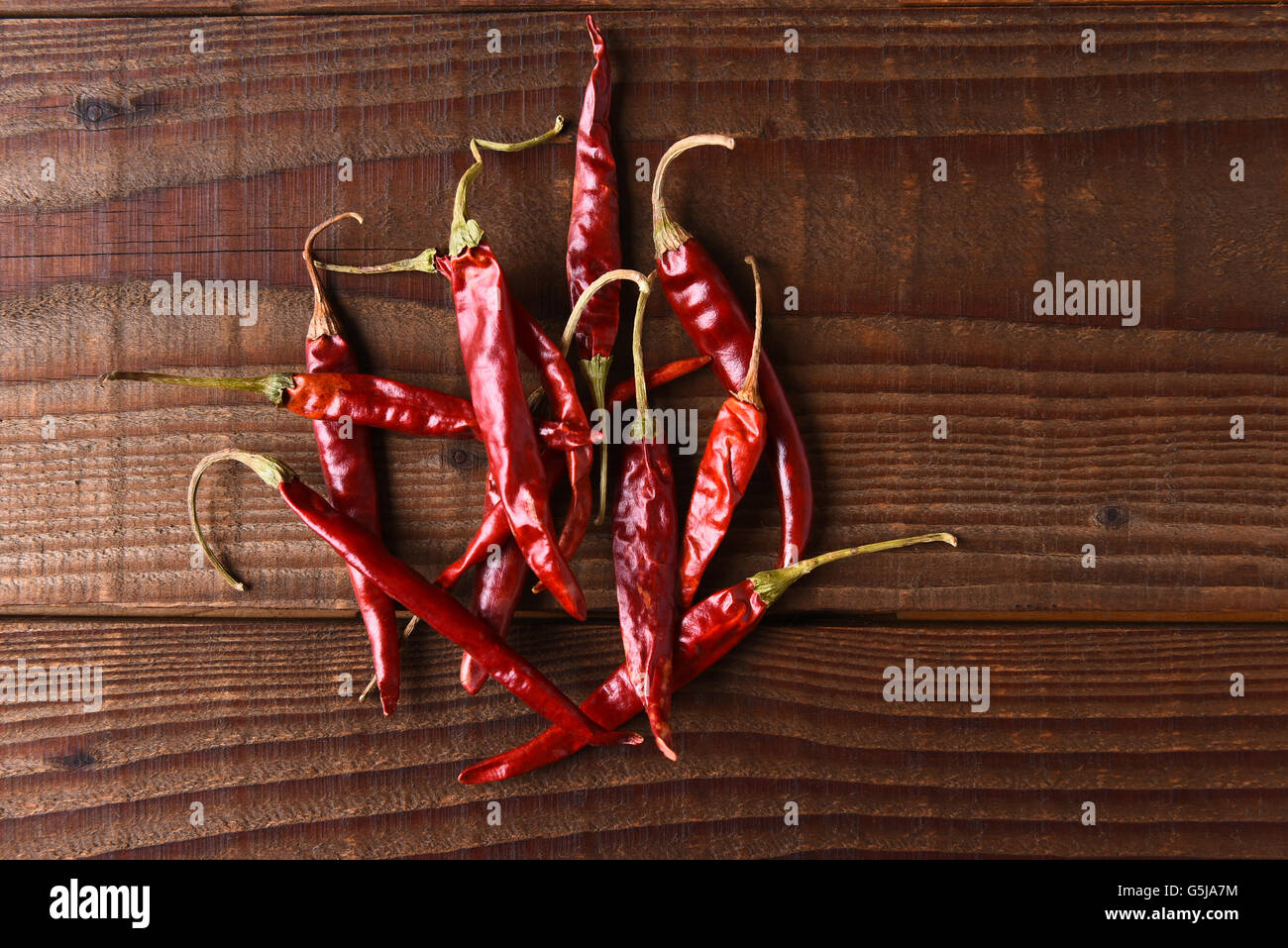 Dried Chili Still Life. Horizontal format on a rustic wood table with copy space. Stock Photo