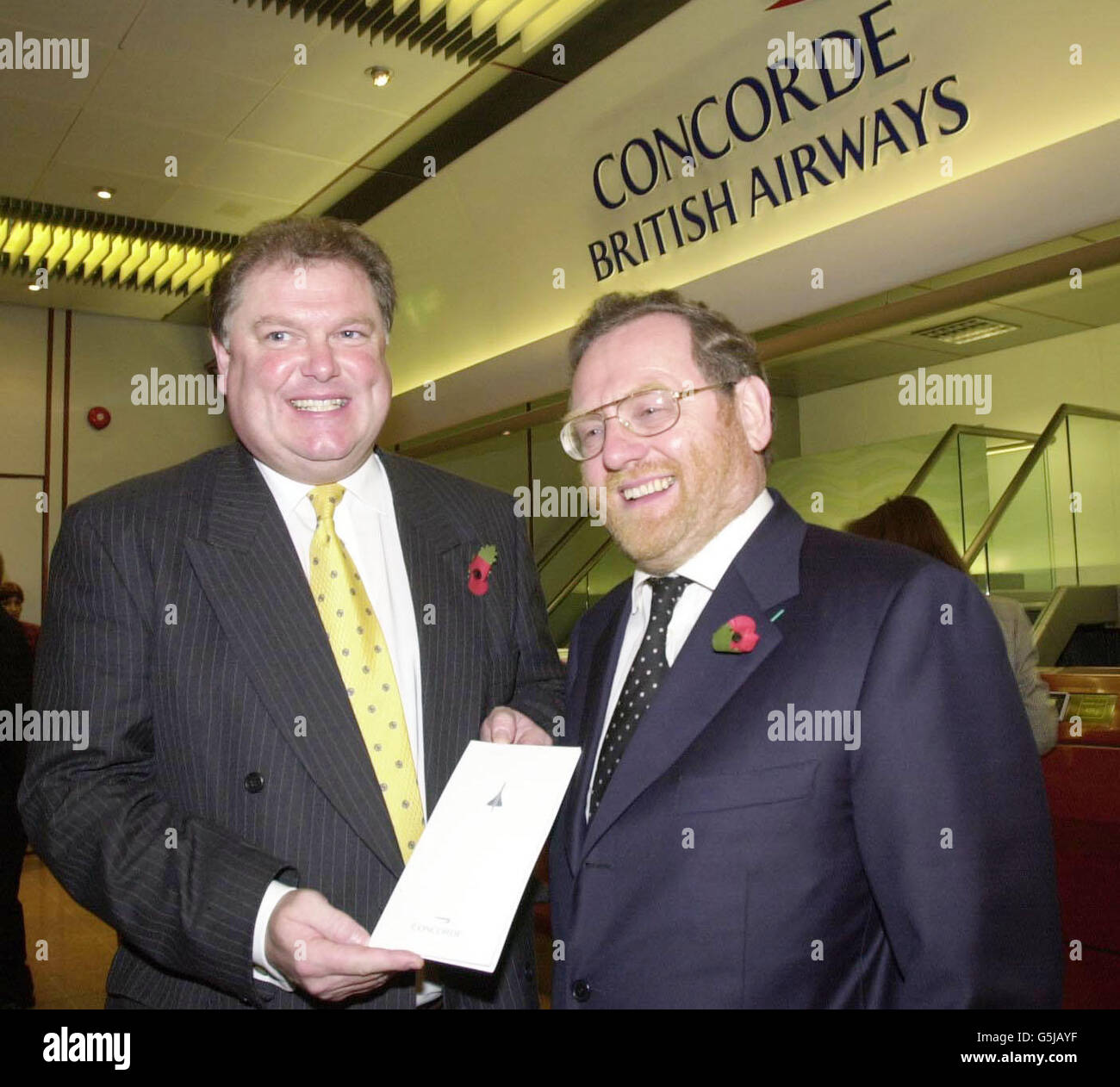 Digby Jones (R) Director General of the CBI alongside John Spellar Minister of Transport at London's Heathrow Airport, British Airways Concorde check-in-desk before they depart on the supersonic aircraft. *... which is due to make its first commercial crossing of the Atlantic since the fleet was grounded for modifications after a crash in France July 2000 which claimed 113 lives. British Prime Minister Tony Blair was expressing his support for the plane by chartering a Concorde to fly later Wednesday from London to Washington DC for talks and dinner with President Bush. Stock Photo