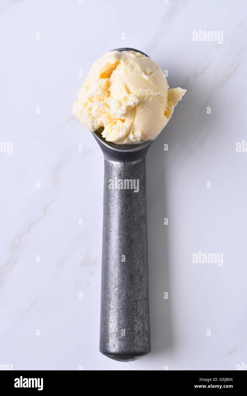 Top view of an ice cream scoop with vanilla ice cream. Vertical format ...
