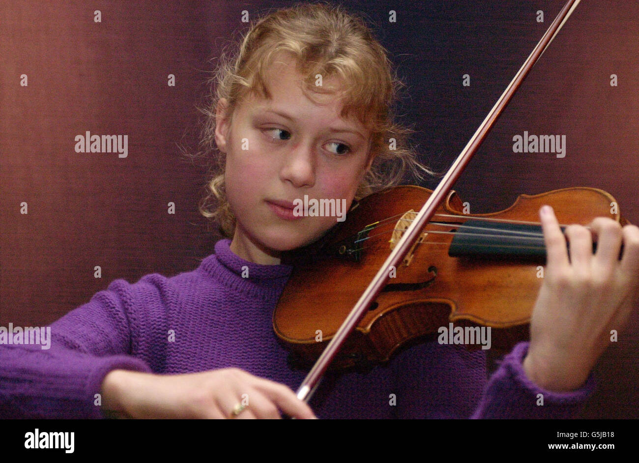 German violin prodigy Maria Elizabeth Lott,14, serenades auction goers with a performance on a Stradivarius violin which is expected to fetch up to 800,000 when it goes on sale at Sotheby's, London. The Le Brun violin, named after its first owner Monsieur le Brun. *... was created in 1712 and is said to be among the best examples of Stradivari's craftsmanship. Stock Photo