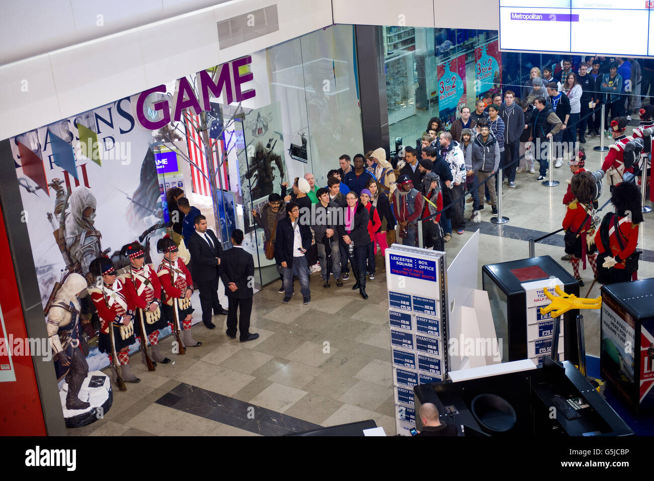 Gamers queue to buy a copy of Assassins Creed III at GAME's flagship Stratford store in London which opened at midnight so fans could get a copy the moment the game was released. Stock Photo