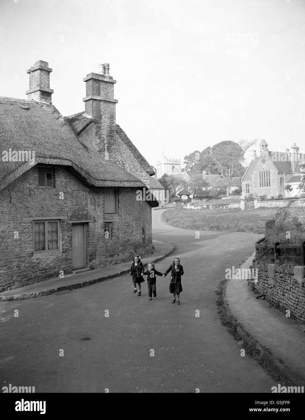 A view of Lullington in Somerset, where the old water pump is no longer working and there is no public house. Stock Photo