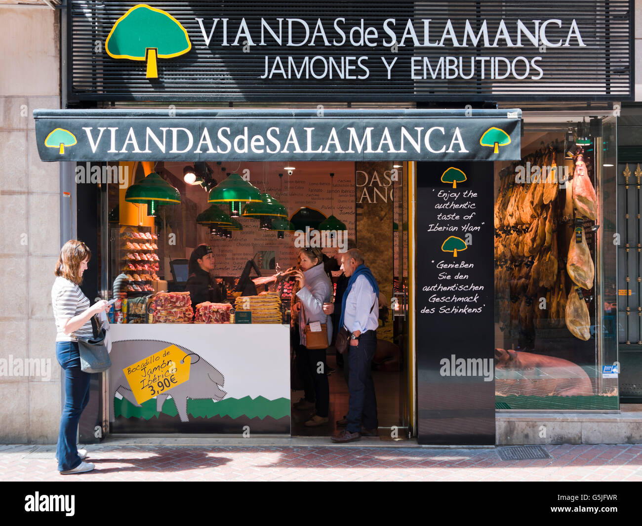 Horizontal view of customers at a traditional Iberian ham delicatessen in Palma, Majorca. Stock Photo