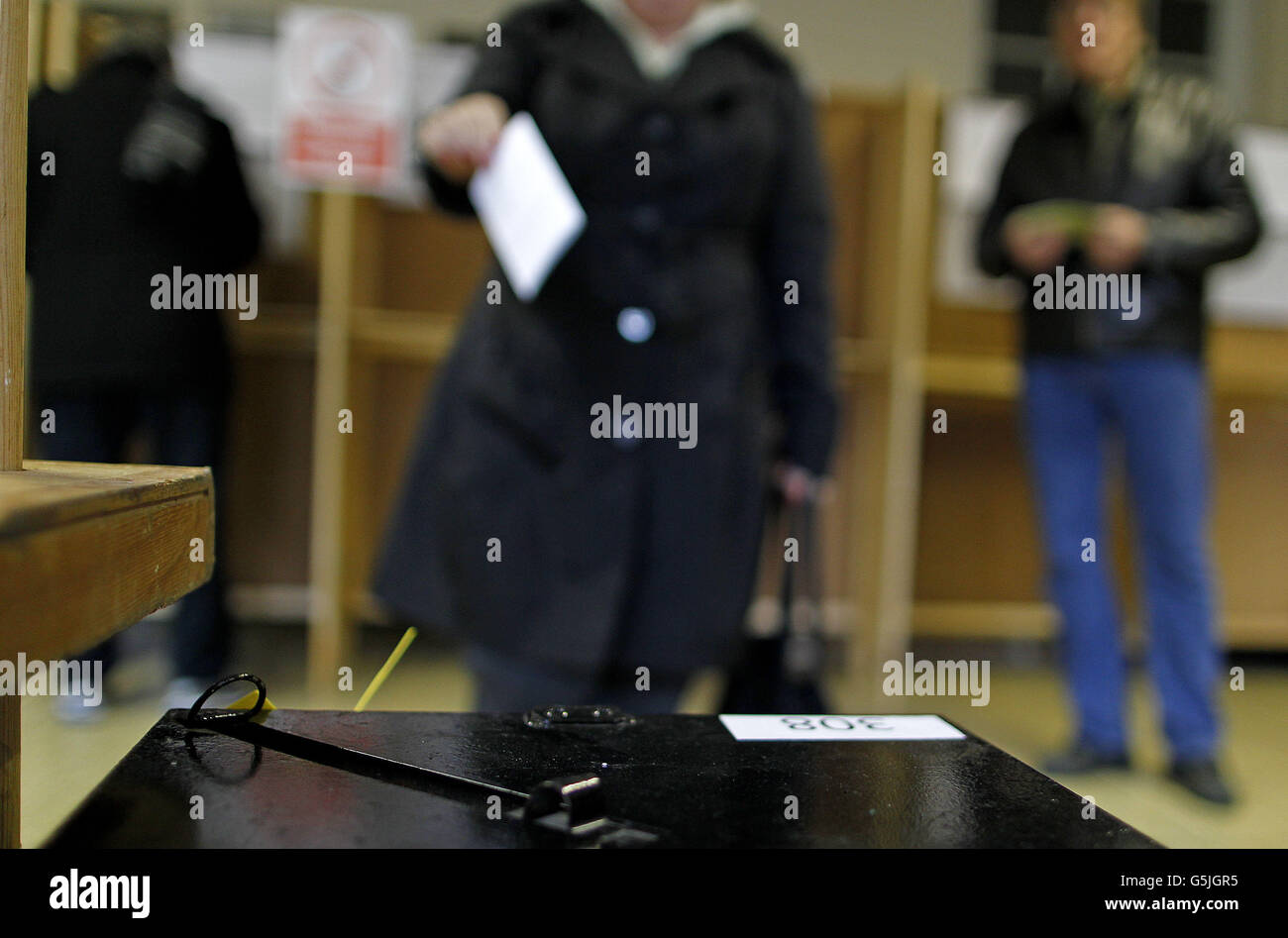 A voter casts her vote at a polling station in Dublin as voting has got under way across Ireland as the public determines if the Government's plans to enshrine children's rights in the constitution should be accepted. Stock Photo