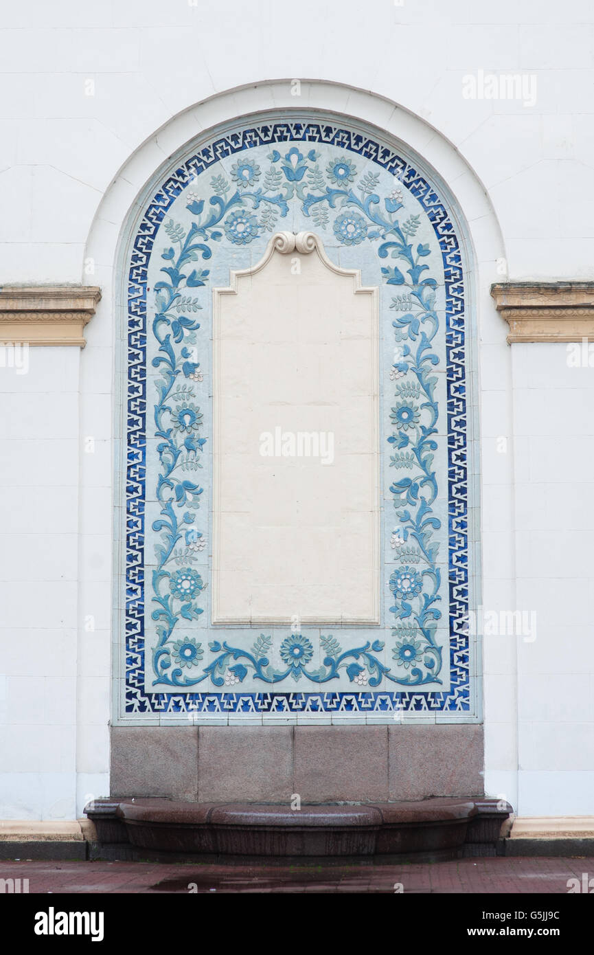 architectural arch on facade of building with blue stucco Stock Photo