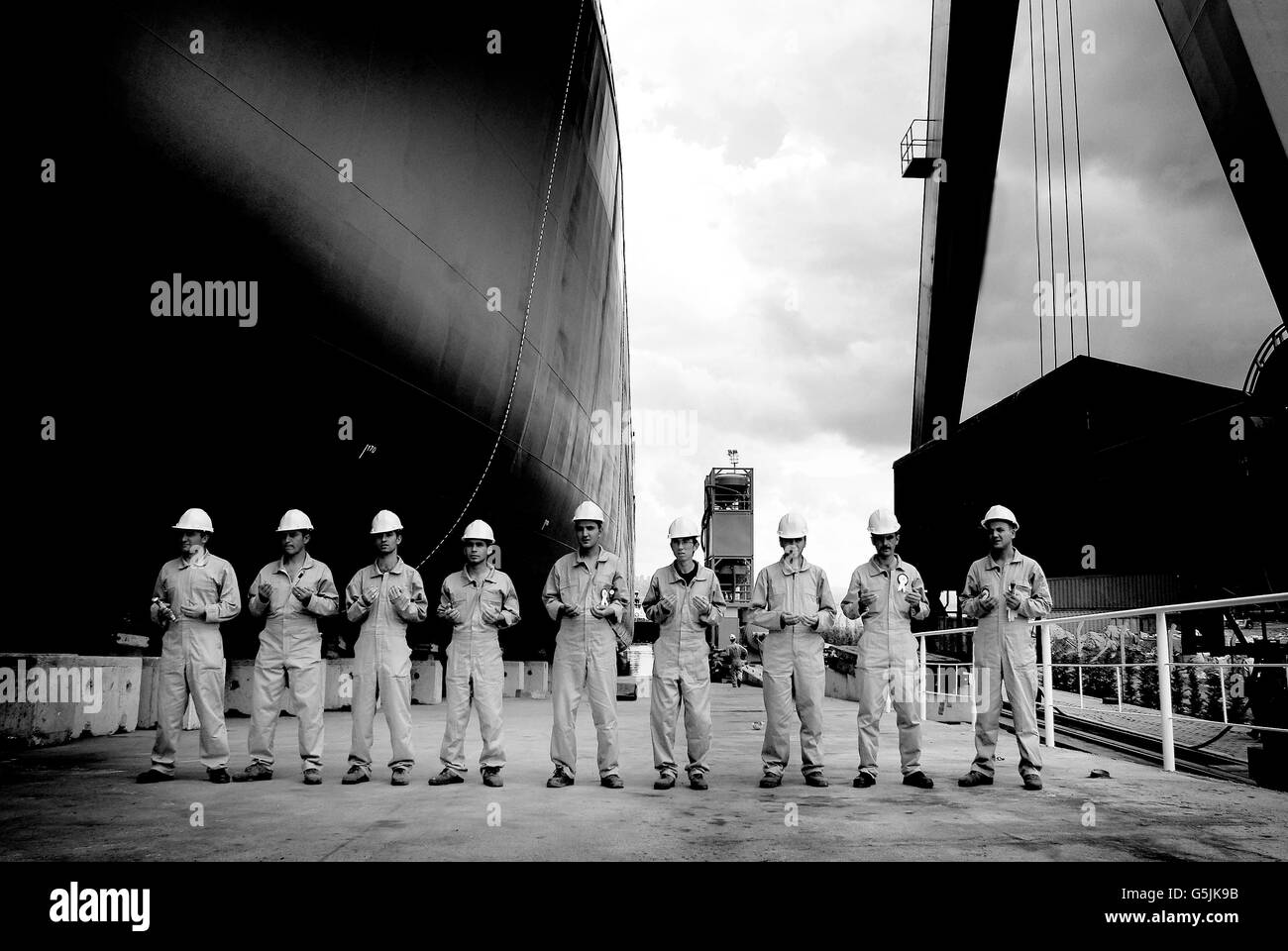 Workers praying for ship which is already finished for voyage. Stock Photo