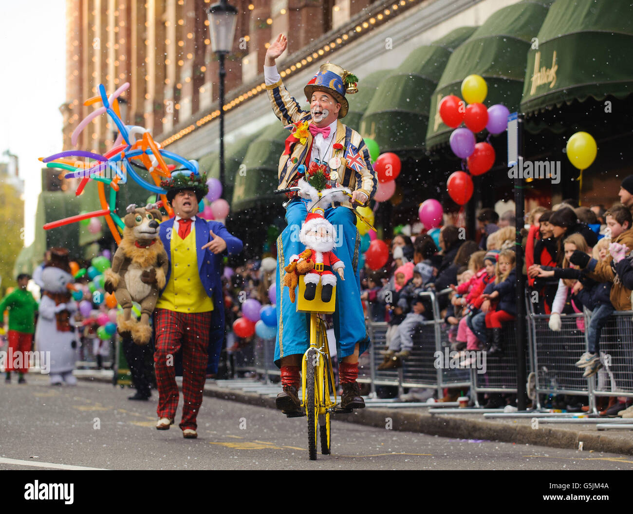 Performers take part in the annual Harrods Christmas Parade outside