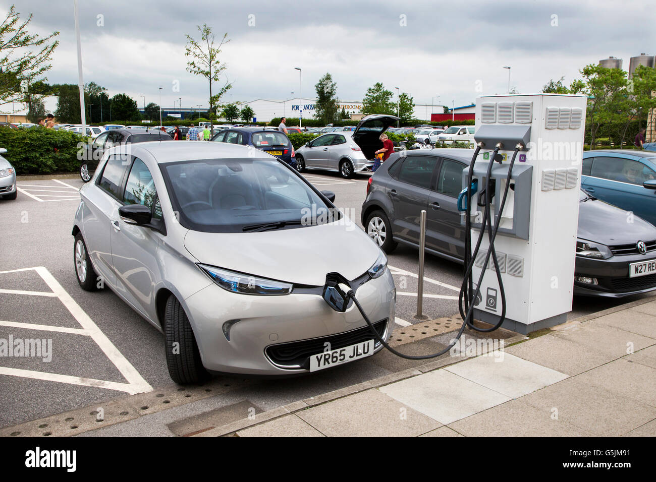 Electric Renault car charging at a recharging point in the car park of