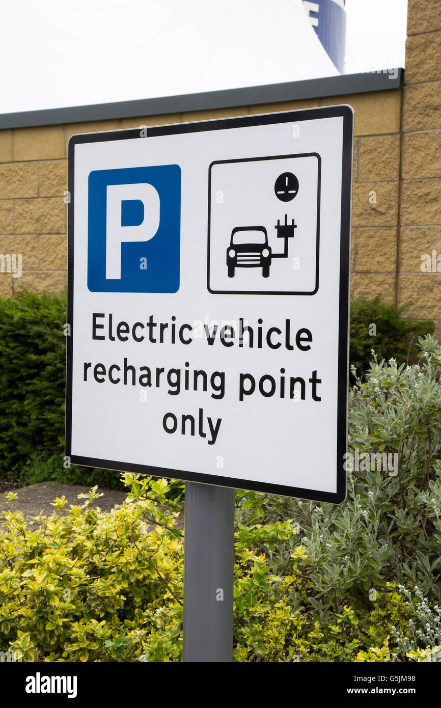 Electric Renault car charging at a recharging point in the car park of a retail shoppping outlet in Doncaster South Yorkshire Stock Photo