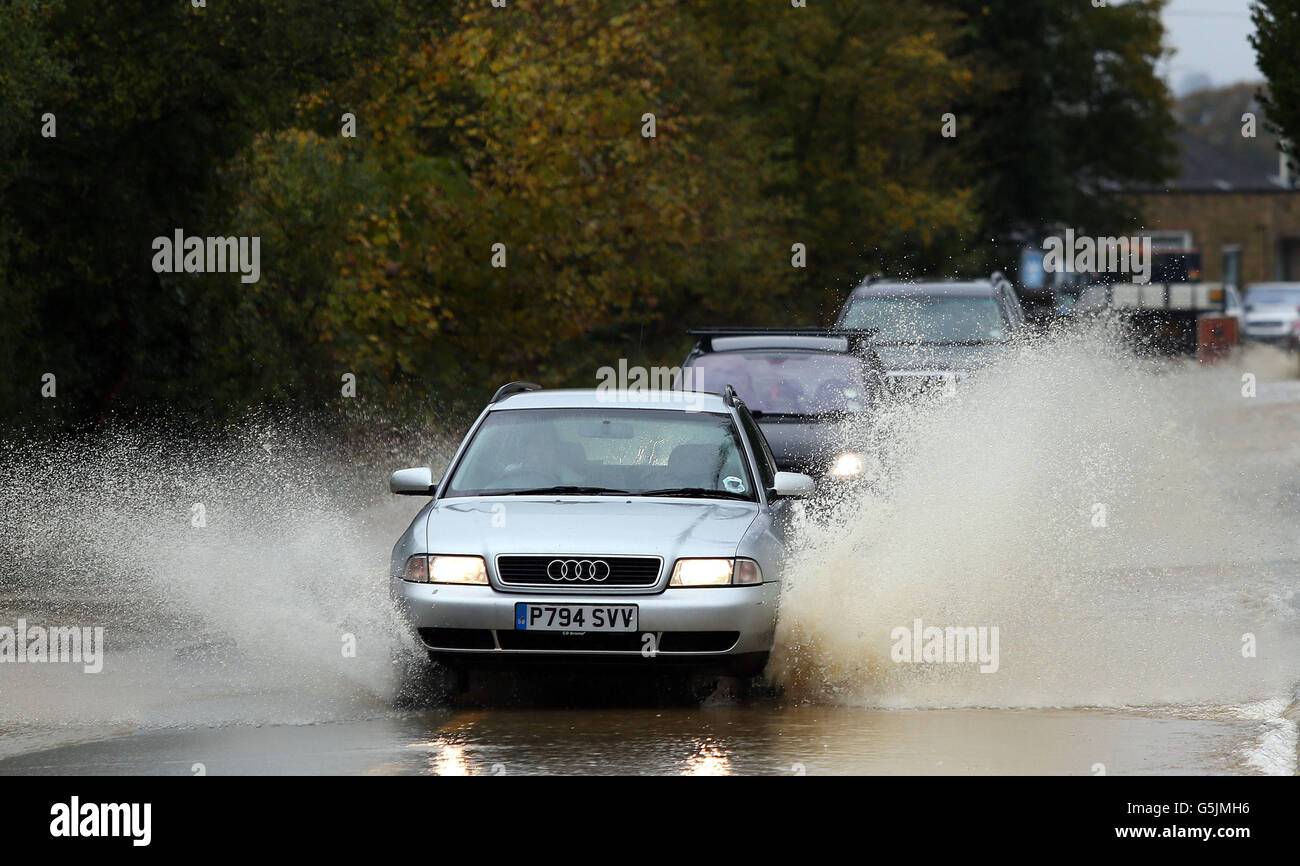 Traffic travels through flooded roads on the A44 near Chipping Norton in the Cotswolds. Stock Photo