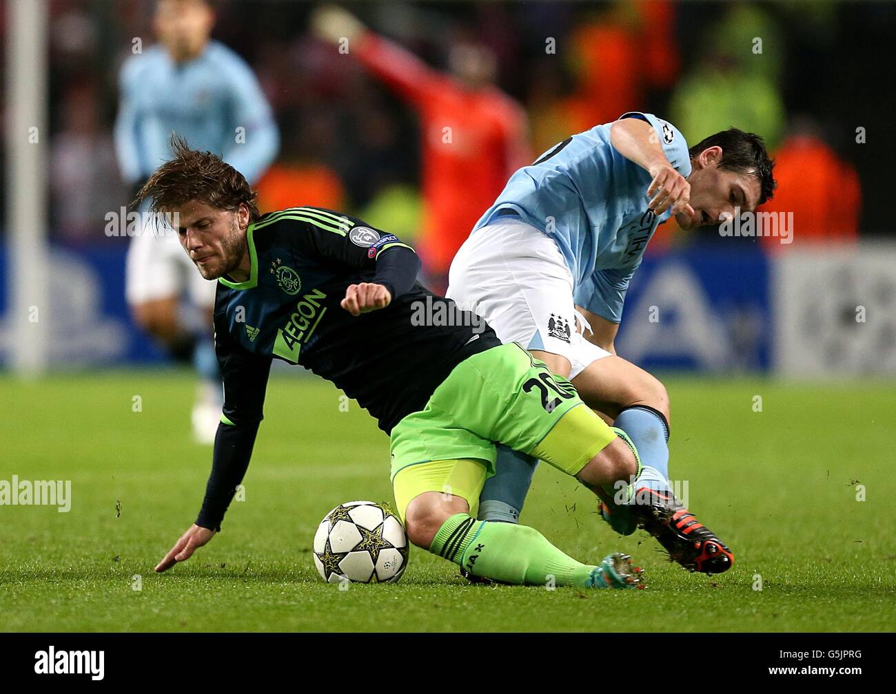 Ajax's Lasse Schone (left) and Manchester City's Gareth Barry battle for the ball Stock Photo