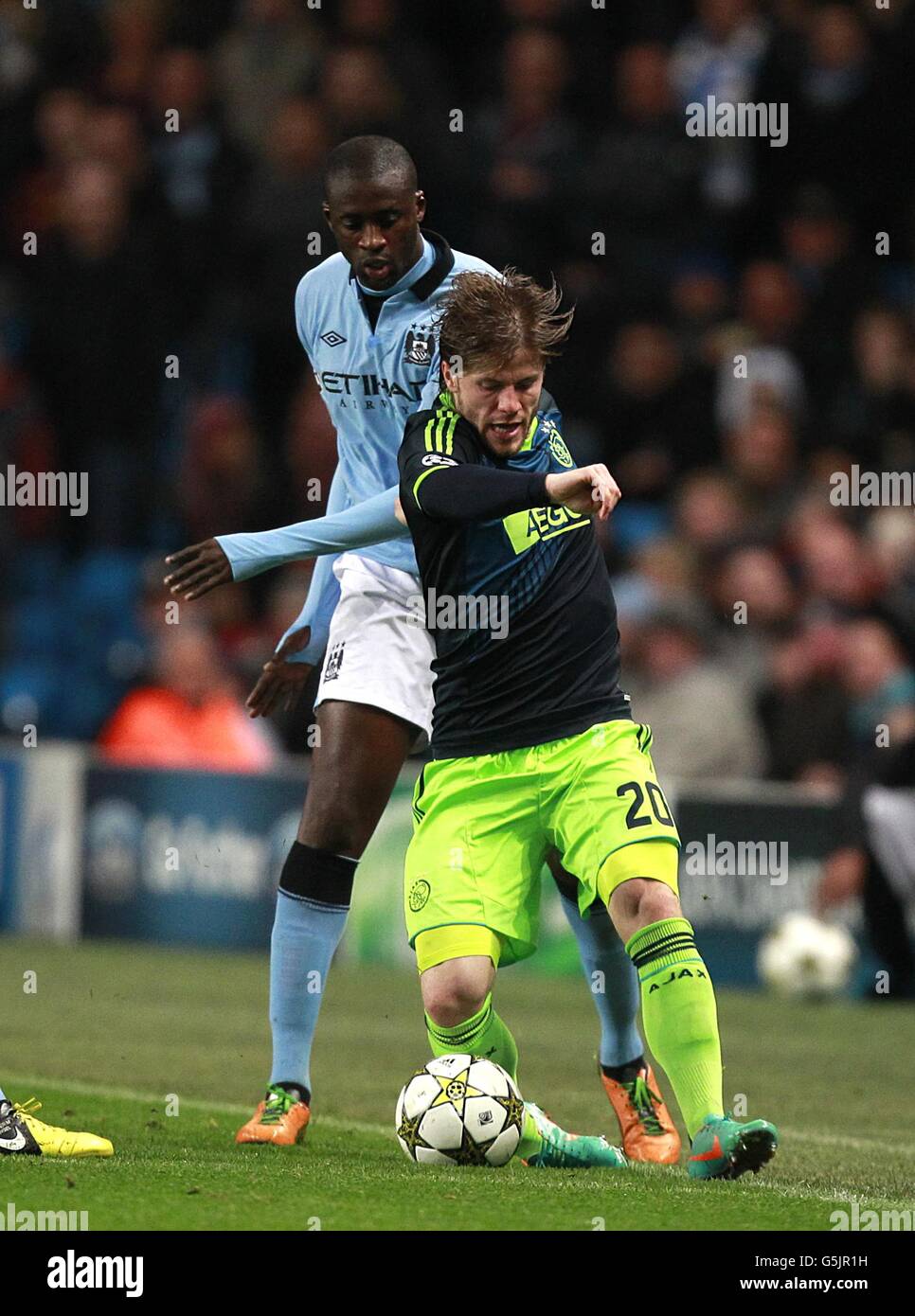 Soccer - UEFA Champions League - Group D - Manchester City v Ajax - Etihad Stadium. Ajax's Lasse Schone and Manchester City's Yaya Toure (left) battle for the ball Stock Photo