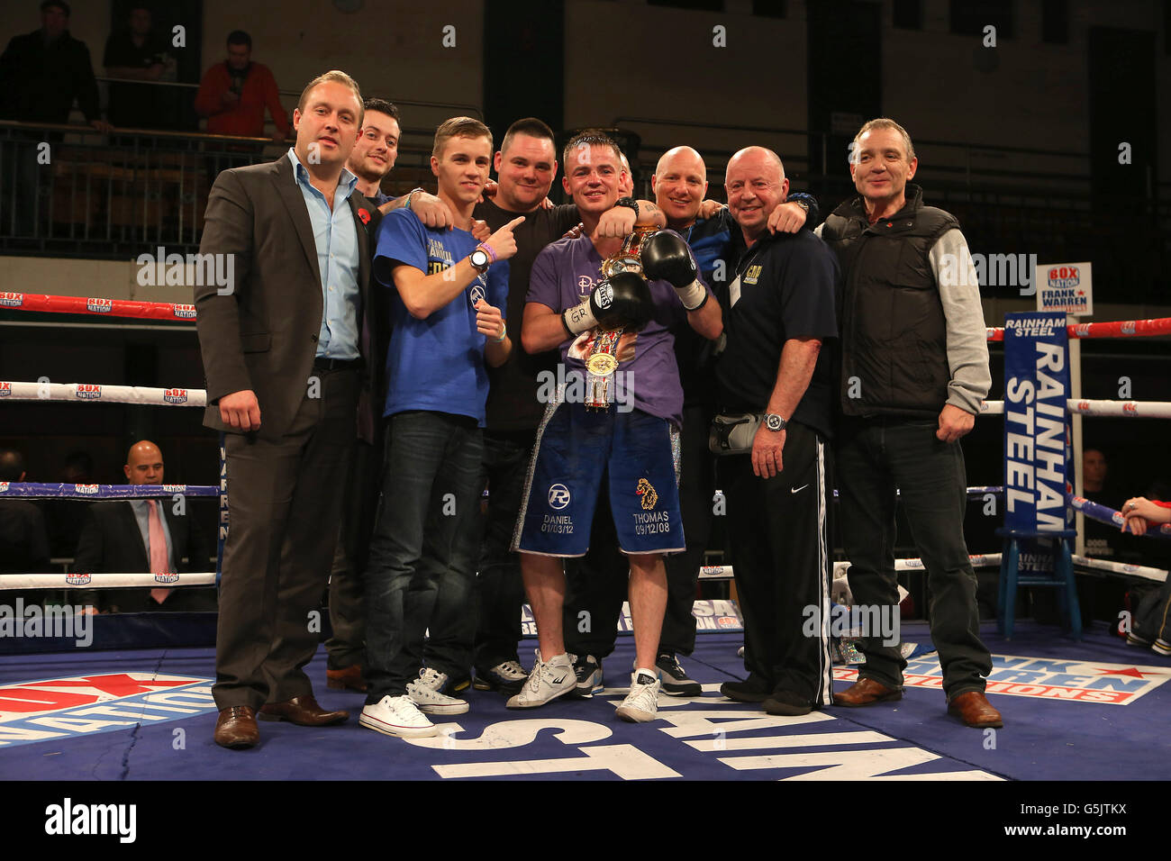 Frankie Gavin celebrates beating Junior Witter with his team including cornerman Kerry Kayes (second right) during the British Welterweight Title fight at York Hall, London. Stock Photo
